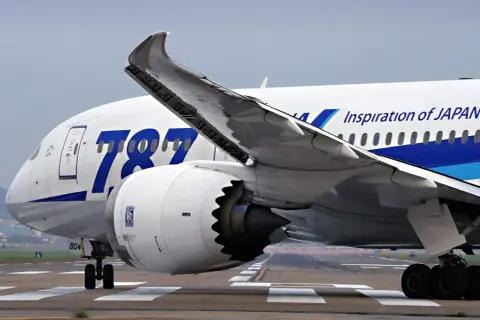 Boeing Dreamliner z napisem "Inspiration of JAPAN" na skrzydle, kołami podwozia i silnikiem Rolls-Royce.