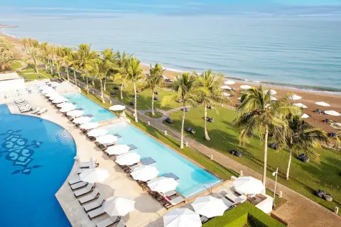 Widok na baseny i plażę z palmami przy Barcelo Hotel. Idealne miejsce na relaks.
